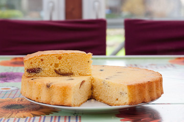 home made sponge cake round with plum and dates