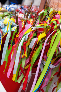 Colorful ribbons on branch on market stall, closeup