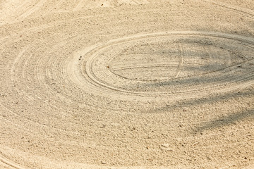 Fototapeta na wymiar close up background of the rough sand field texture with many circle lines in the golf course