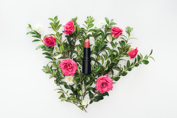 top view of lipstick on flowers composition on white background