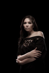 portrait of young brunette girl with black tears from eyes and lace pattern on face and neck posing...