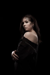 portrait of young brunette girl with black tears from eyes and lace pattern on face and neck posing...