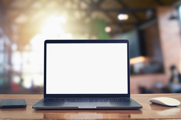 Fototapeta premium laptop computer blank white screen and mobile on table in cafe background