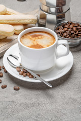 Italian Savoiardi ladyfingers Biscuits and cup of coffee on concrete backgound