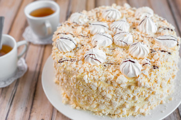 Cake delicious on plate. Bakery, cream dessert cake with tea spot on wooden table