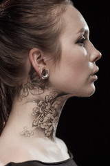 Beautiful portrait of a young brunette woman with black eyes and a lacy pattern on her face and...