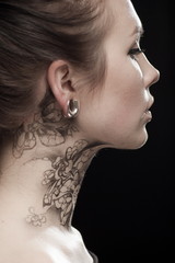Beautiful portrait of a young brunette woman with black eyes and a lacy pattern on her face and...