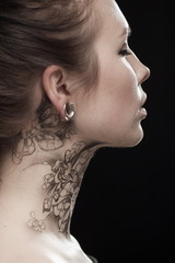 Beautiful portrait of a young brunette woman with black eyes and a lacy pattern on her face and...