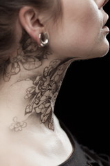 Beautiful portrait of a young brunette woman with black eyes and a lacy pattern on her face and...