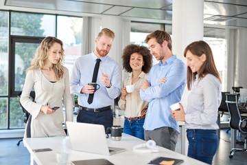 Small group of business people standing at office and solving problem at meeting. Multi cultural group.