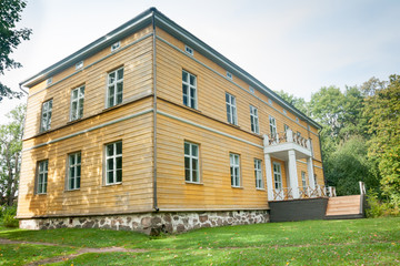 Fototapeta na wymiar KOUVOLA, FINLAND - SEPTEMBER 20, 2018: Beautiful yellow old building of abandoned Anjala manor. The building was built at the turn of the 19th century and belonged to the Wrede family from 1837