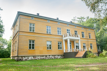 Fototapeta na wymiar KOUVOLA, FINLAND - SEPTEMBER 20, 2018: Beautiful yellow old building of abandoned Anjala manor. The building was built at the turn of the 19th century and belonged to the Wrede family from 1837
