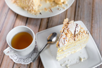 Cake delicious on plate. Bakery, cream dessert cake with tea spot on wooden table
