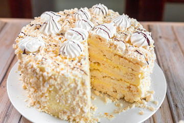 Cake delicious on plate. Bakery, cream dessert cake with tea spot on wooden table