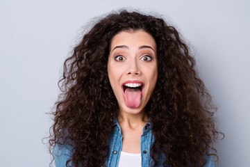 Close-up portrait of her she nice-looking cute charming attractive lovely crazy cheerful positive naughty wavy-haired girl showing tongue isolated over gray pastel background © deagreez