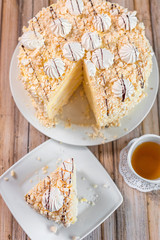 Cake delicious on plate. Bakery, cream dessert cake with tea spot on wooden table