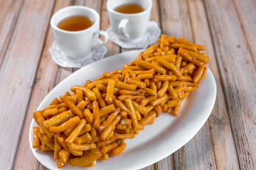 Baked sugar food dessert on wooden plate. Cookies and pastry