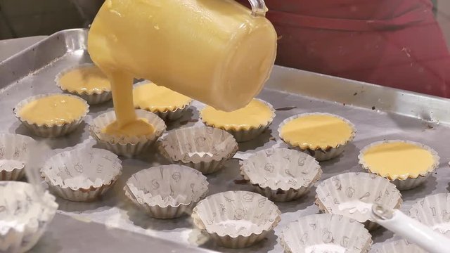 Motion of worker making lemon cupcake inside Burnaby shopping mall with 4k resolution