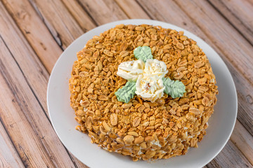 Cake delicious on plate. Bakery, cream dessert cake with tea spot on wooden table