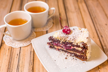 Cake delicious on plate. Bakery, cream dessert cake with tea spot on wooden table