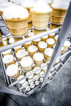 Ice cream standing in stack in milk factory fridge