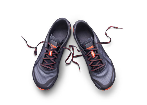 Top view of gray and orange trainers isolated on a white background.