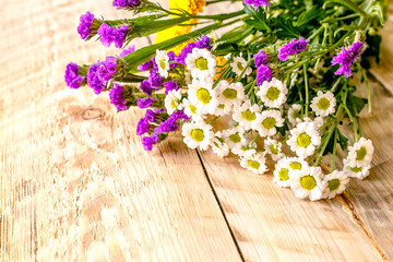 Spring flowers on wooden board