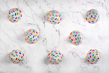 Above view on party hats on marble pattern background. Abstract birthday background. Flat lay