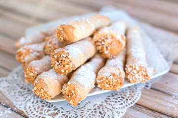 Delicicous cookies with nuts and cream on plate