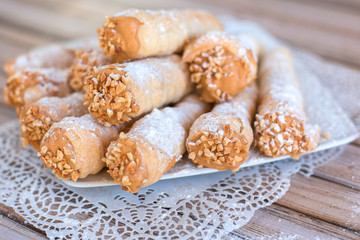Delicicous cookies with nuts and cream on plate