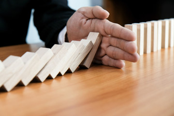 Planning risk and strategy in businessman gambling placing wooden block.Business concept for growth...