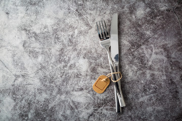 Fork and knife with empty label on table