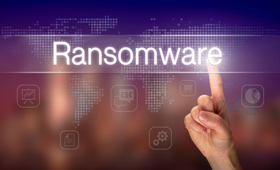 A hand selecting a Ransomware business concept on a clear screen with a colorful blurred background.