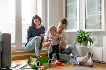 Young parents playing with baby son