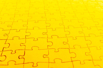 Assembled puzzle on a bright yellow background.