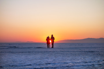 People figures at sunset in winter