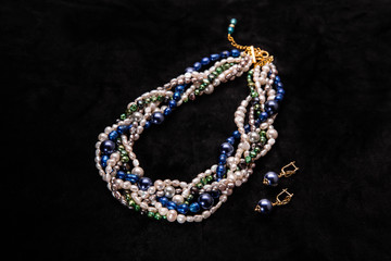 A multi-colored beads from pearls with earrings darkly blue
