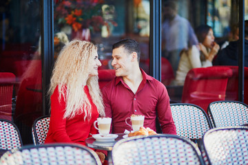 Beautiful romantic couple in Parisian outdoor cafe