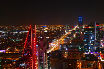 Panorama view to the skyline of Riyadh by night, with skyscrapers in the background and busy traffic on the streets of Riyadh, the capital of Saudi Arabia