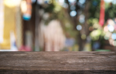 Empty dark wooden table in front of abstract blurred bokeh background of restaurant . can be used for display or montage your products.Mock up for space.