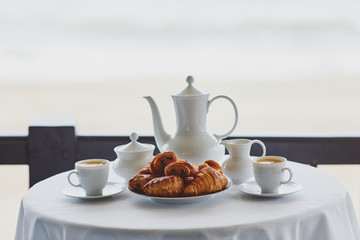 Two cups of coffee and traditional French pastry in cafe or restaraunt