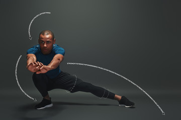 Always in a great shape. Sportsman is stretching standing over dark background. Graphic drawing.