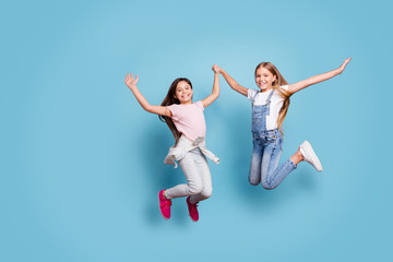 Fototapeta na wymiar Full length body size view of two people nice cute lovely attractive cheerful cheery careless straight-haired pre-teen girls having fun great day isolated over blue pastel background