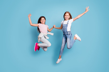 Full length body size view of two people nice-looking crazy cute lovely attractive cheerful careless straight-haired pre-teen girls having fun great day overjoy isolated over blue pastel background