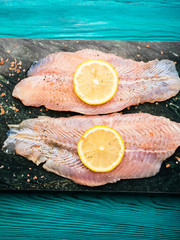 Red perch fillet on green marble board