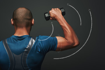 Improve your shape. Dark skinned sportsman working out with dumbbells over dark background. Graphic...
