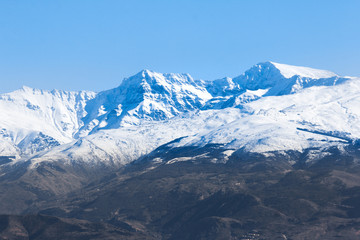 Fototapeta na wymiar Snow capped mountain peak