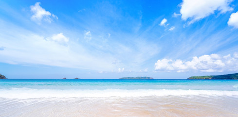 Beautiful amazing gold colored sandy beach with soft waves isolated with sunny blue sky. Concept of tropical calm tourism idea, copy space, close up