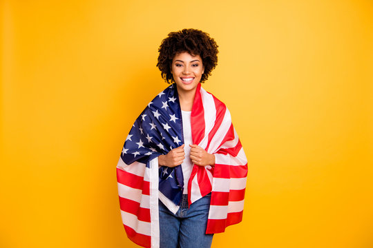 Close up photo beautiful amazing she her dark skin lady hands arms hold american flag best country party 4th of july wearing casual jeans denim white t-shirt isolated yellow bright vibrant background