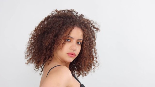some takes how mixed race woman turning to a camera with hair shaking in slow motion from 60 fps
